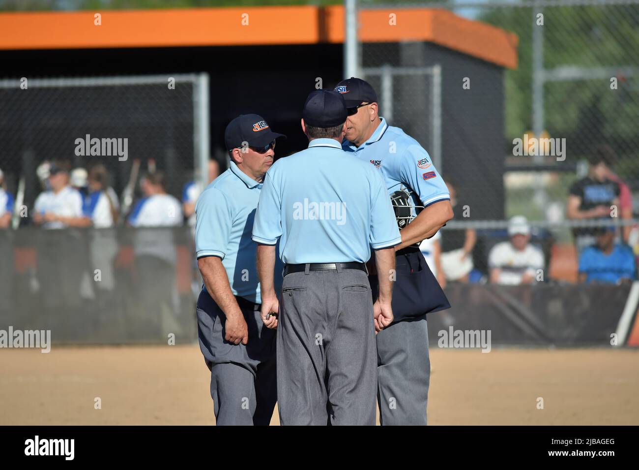 USA. Umpires confer before reaching a decision that took a run off the board for the team whose at bat had just concluded due to a interference call. Stock Photo