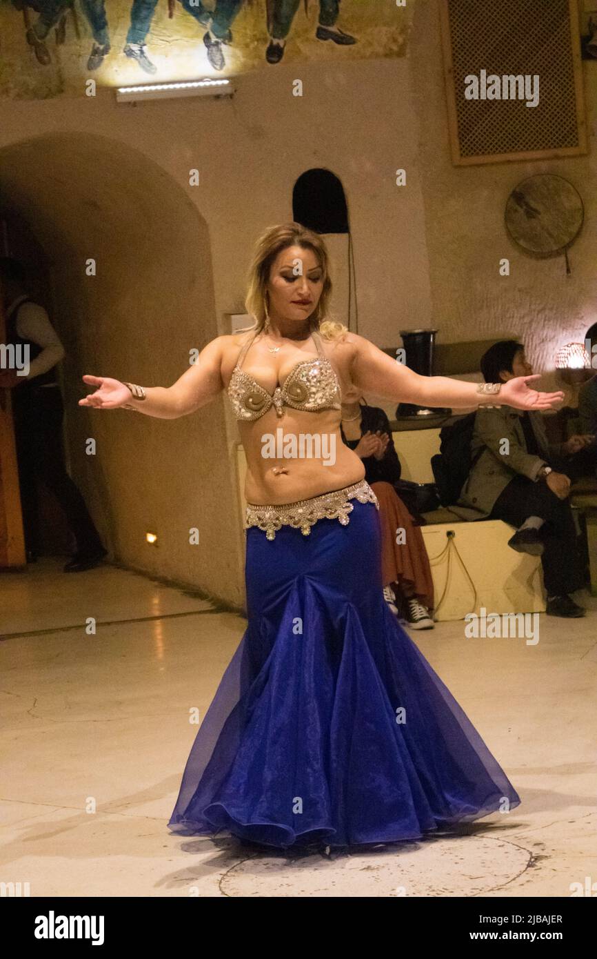 a turkish female dancer performing a küçek-belly dance for tourists in a local restaurant Stock Photo