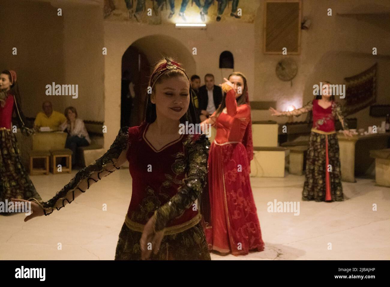 Traditional Turkish dancers dance for tourists in a local restaurant Stock Photo