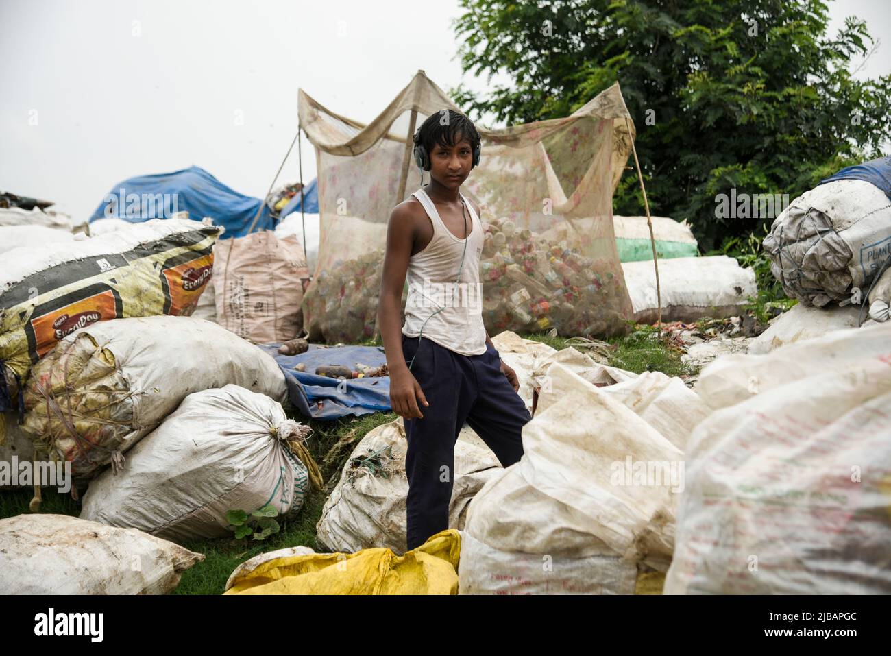 A rag picker posed for photo at a garbage dumpsite, in Guwahati, Assam, India on 04 June 2022. World Environment Day 2022 is the biggest international day for the environment. Led by the United Nations Environment Programme (UNEP) on 05 June every year. Credit: David Talukdar/Alamy Live News Stock Photo