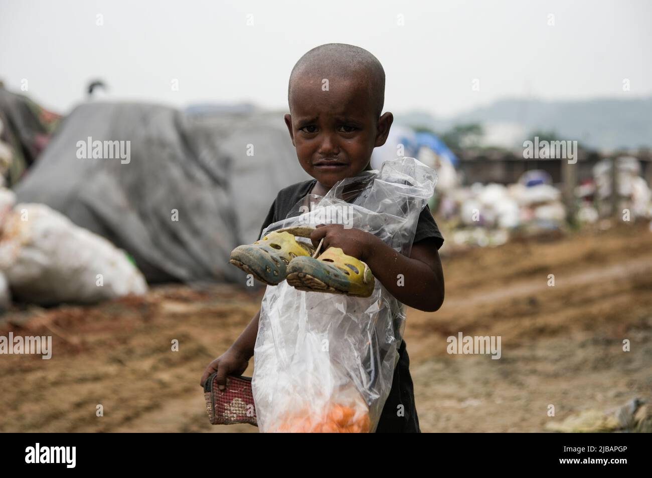 A child crying at a garbage dumpsite in the eve of World Environment Day, in Guwahati, Assam, India on 04 June 2022. World Environment Day 2022 is the biggest international day for the environment. Led by the United Nations Environment Programme (UNEP) on 05 June every year. Credit: David Talukdar/Alamy Live News Stock Photo