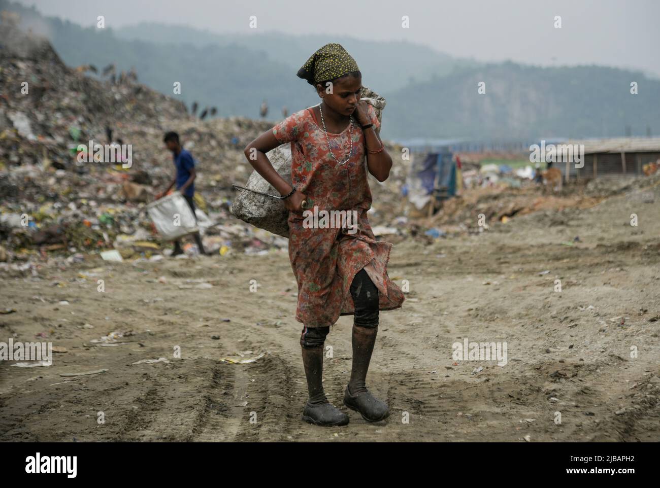 A girl rag picker at a garbage dumpsite, in Guwahati, Assam, India on 04 June 2022. World Environment Day 2022 is the biggest international day for the environment. Led by the United Nations Environment Programme (UNEP) on 05 June every year. Credit: David Talukdar/Alamy Live News Stock Photo
