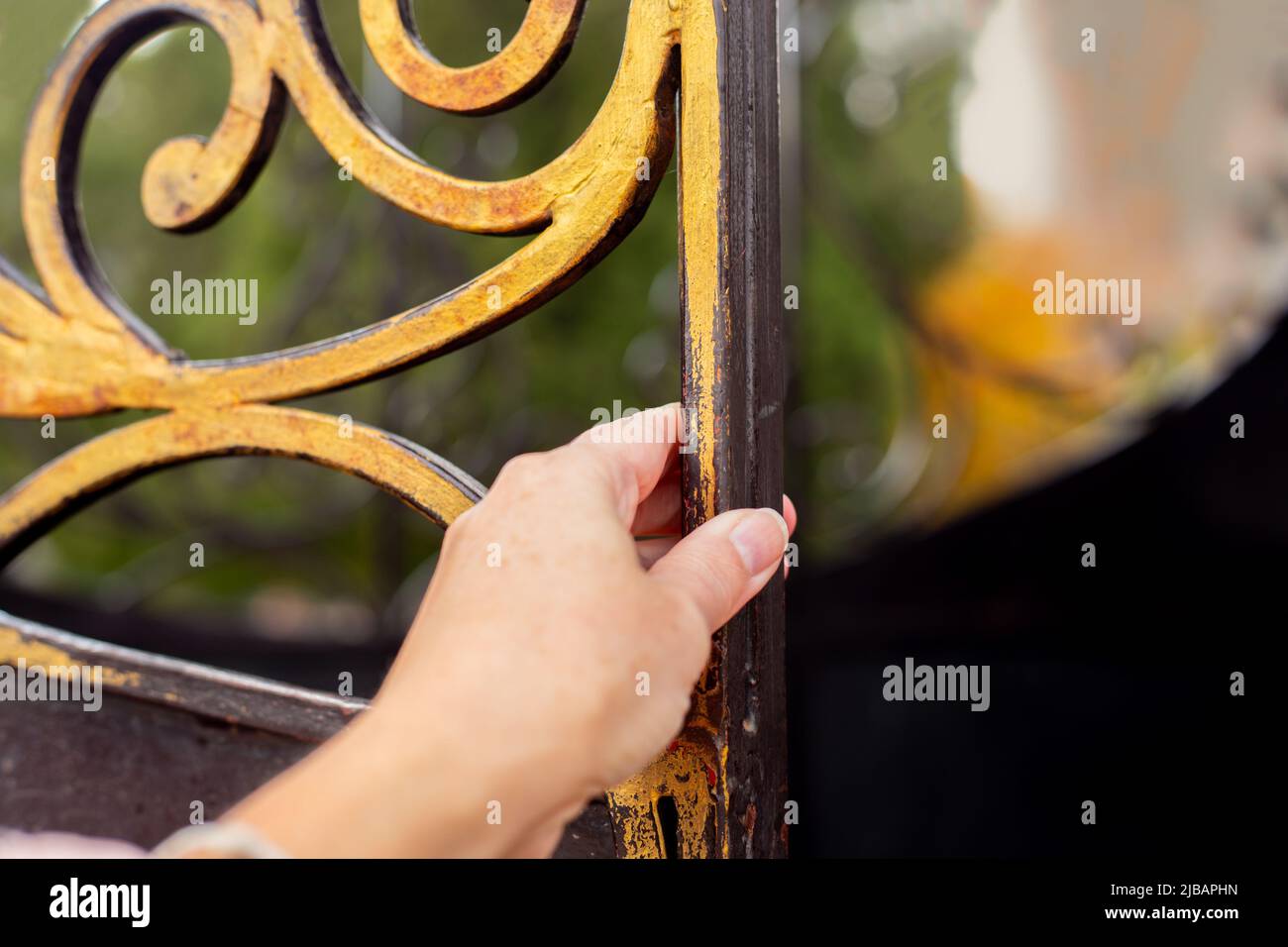 A woman's hand opens a golden door. Enter another life Stock