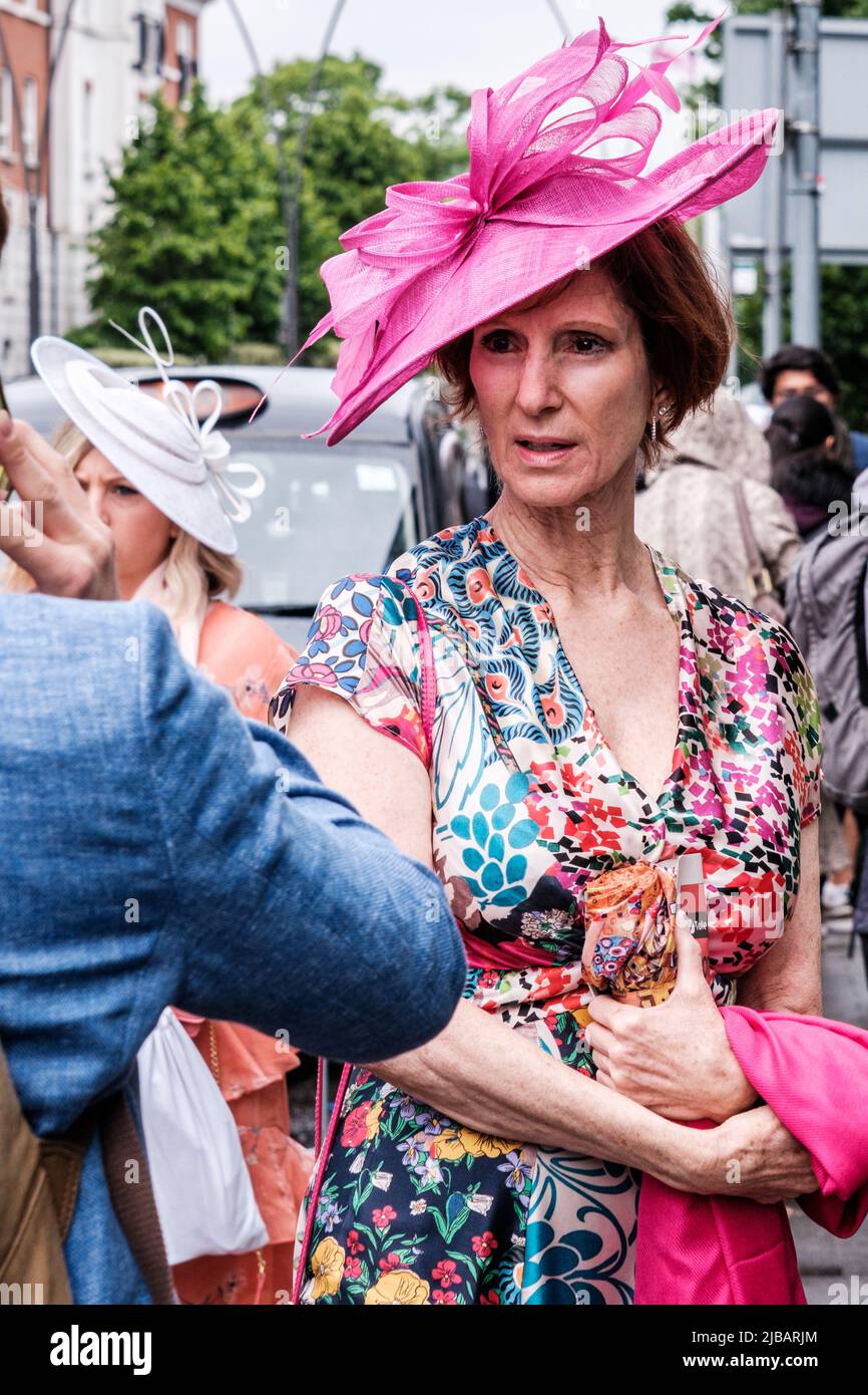 Epsom Surrey, London UK, June 04 2022, Attractive Older Woman Wearing Floral Print Summer Dress And Pink Headwear Stock Photo