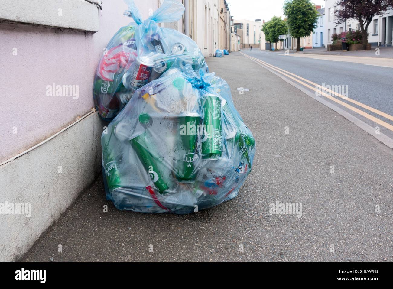 Large number of beer cans in trash left outside home in Carmarthen town, Wales Stock Photo