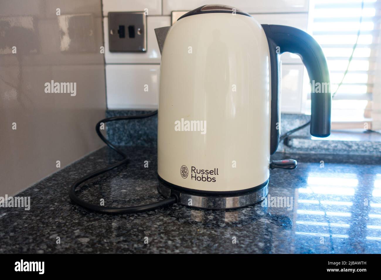 Russell Hobbs kettle plugged and on top of the kitchen Stock Photo