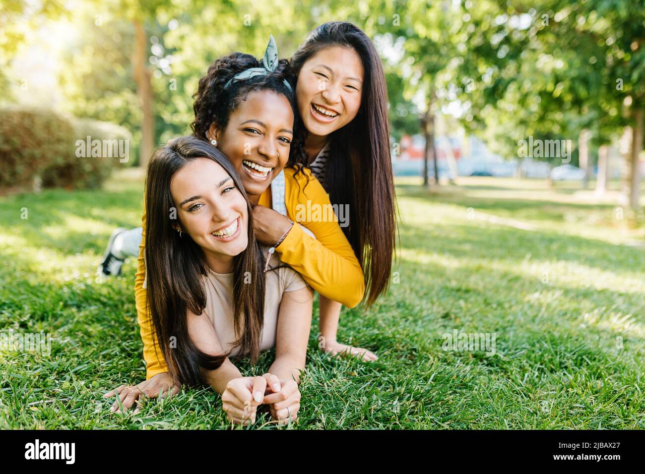 Happy young women best friends having fun together outdoors Stock Photo