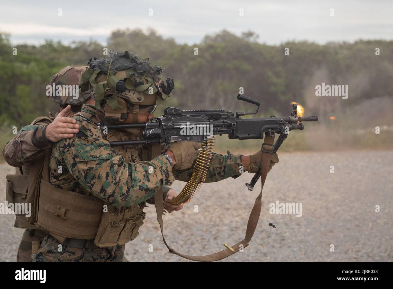 A U.S. Marine with 3rd Battalion, 6th Marine Regiment, 2d Marine Division, and a French Foreign  Legionnaire with 2nd Regiment, fires the FN Minimi at Nimes, France, May, 24, 2022. This was part of a bilateral training event with the French Foreign Legion that challenged the forces with physical and tactical training, as well as provided the opportunity to exchange knowledge and strengthen bonds.. (U.S. Marine Corps photo by Cpl. Michael Virtue) Stock Photo