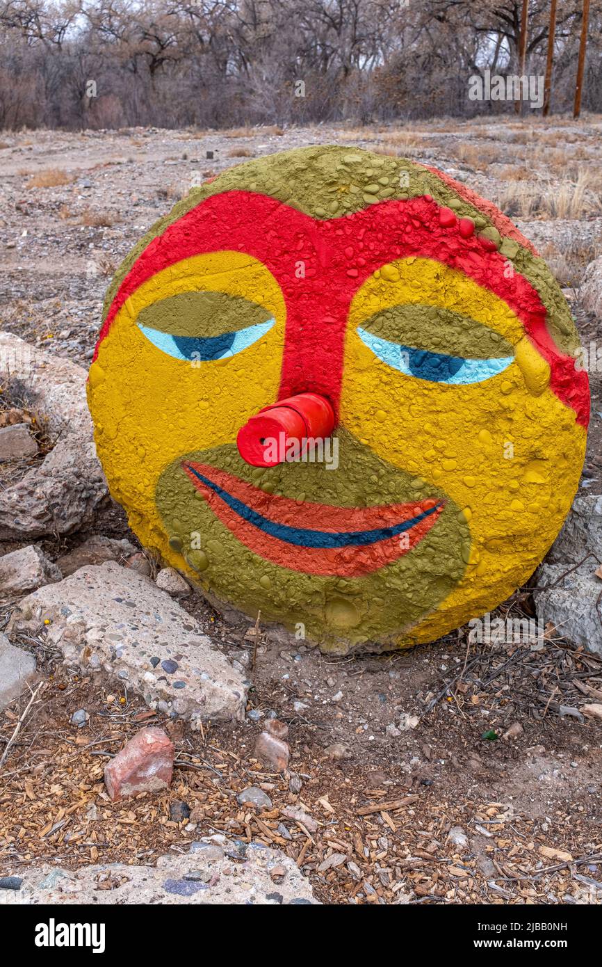painted face on large concrete block (environmental art) along the Paseo del Bosque Trail - City of Albuquerque Stock Photo