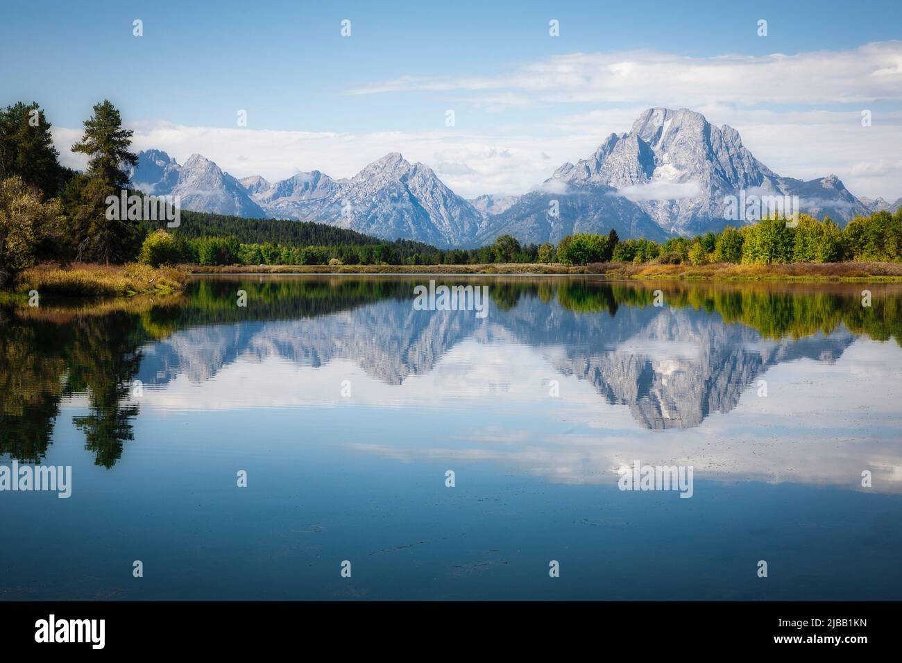 Mount Moran reflects in the still waters of the Snake River at Oxbow Bend in Wyoming. Stock Photo
