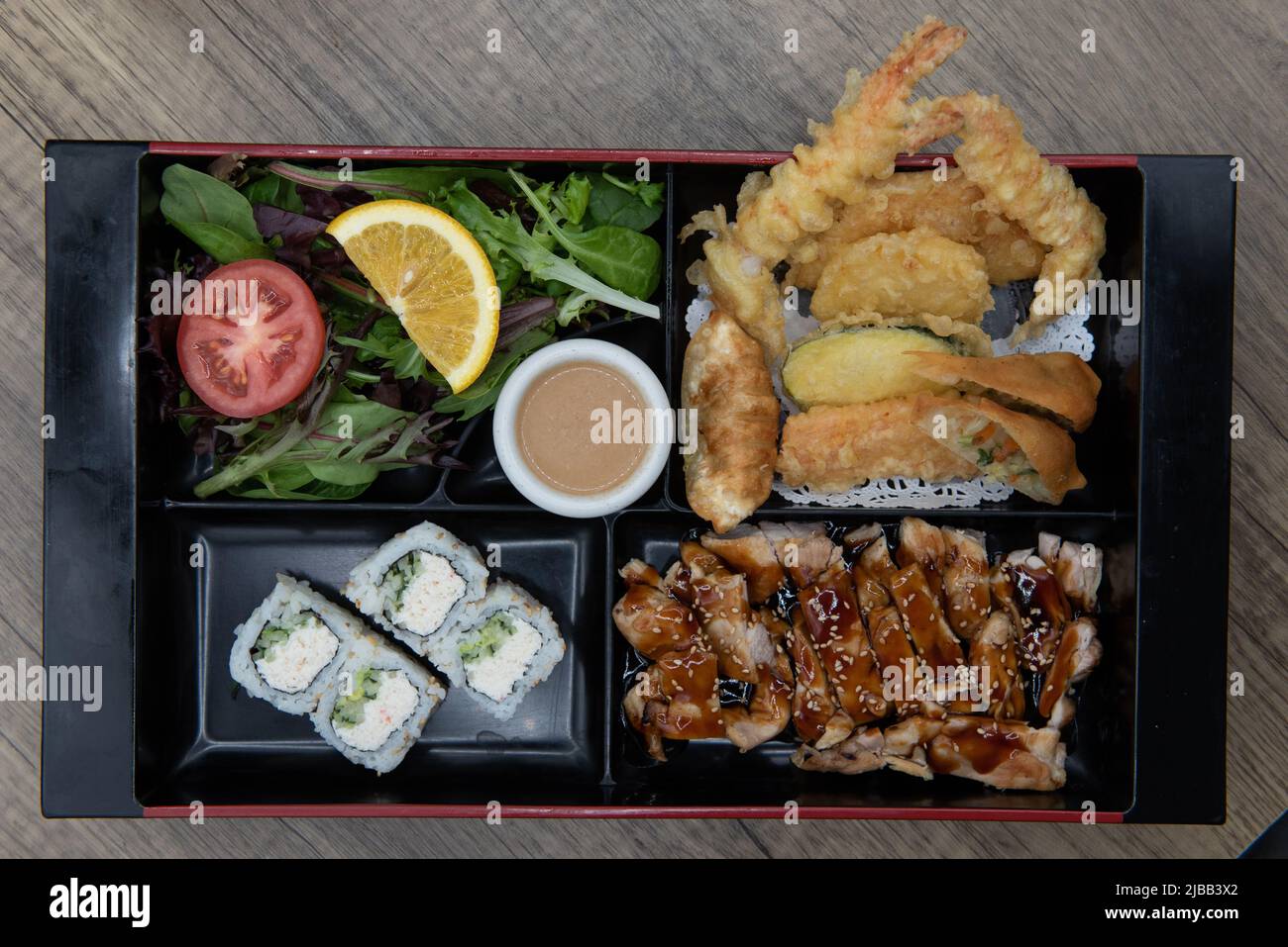 Overhead view of Asian cuisine traditional bento box divided into space