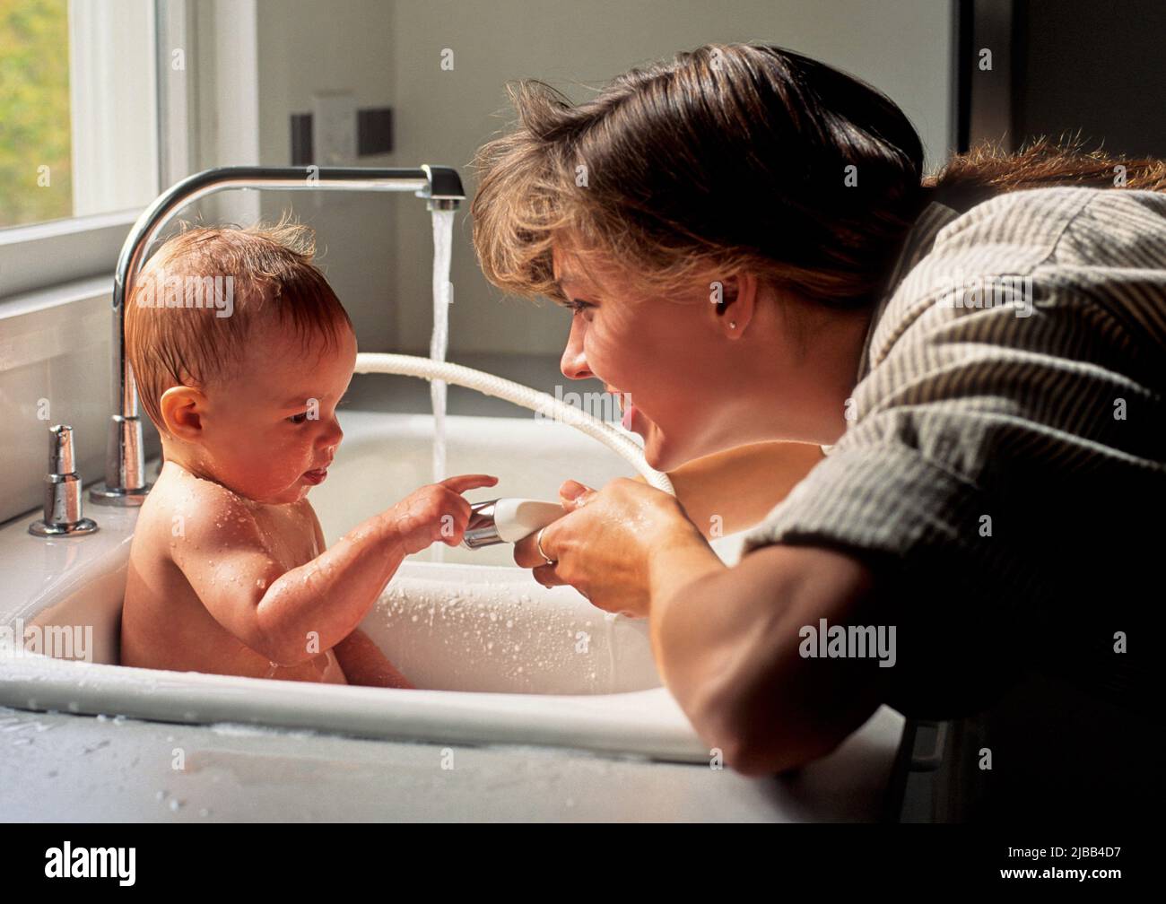 Mother bathing her baby Stock Photo Alamy