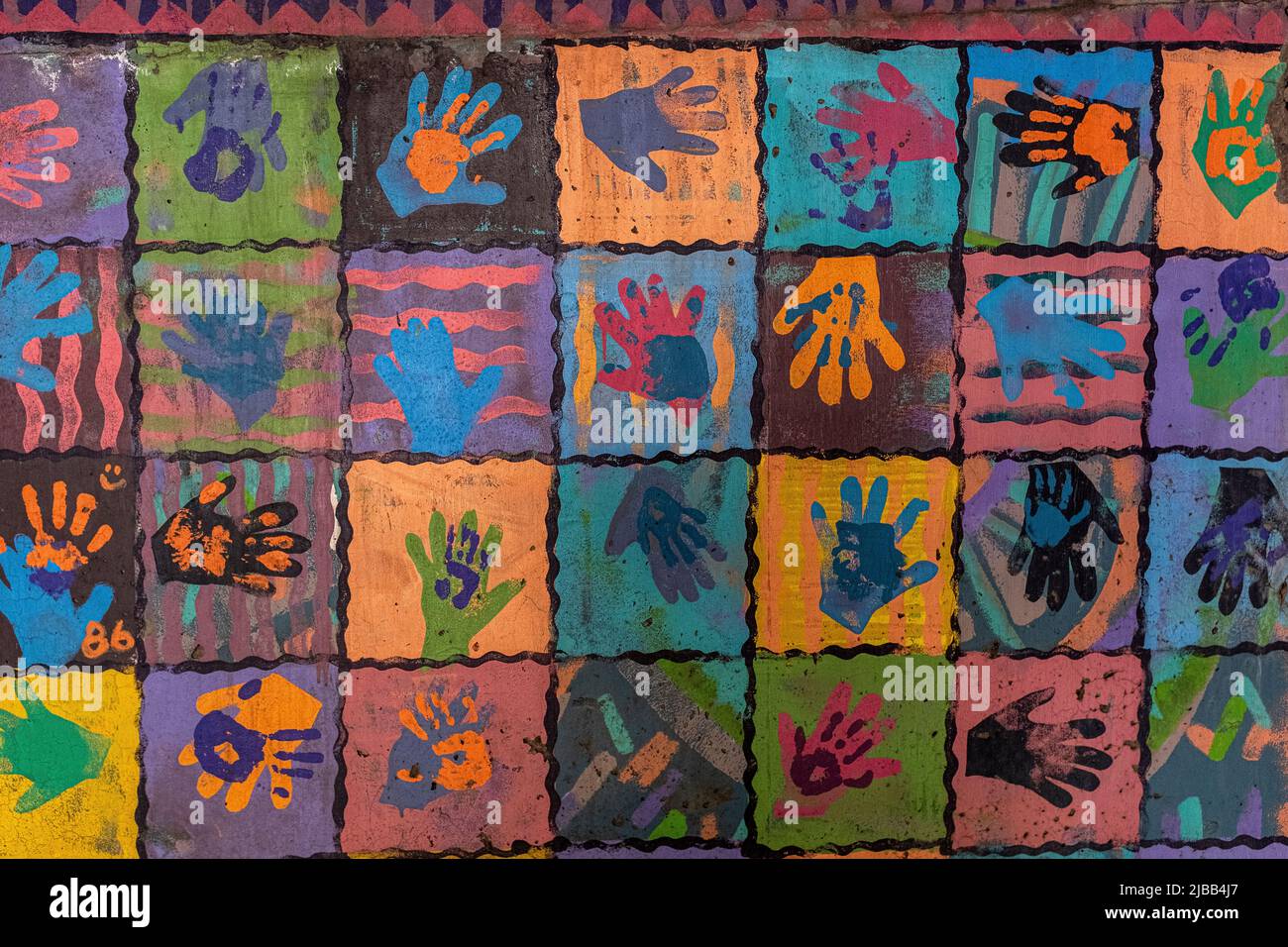 colored hand prints on wall of parking lot in downtown Albuquerque, New Mexico Stock Photo