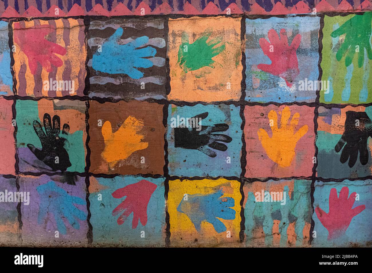 colored hand prints on wall of parking lot in downtown Albuquerque, New Mexico Stock Photo
