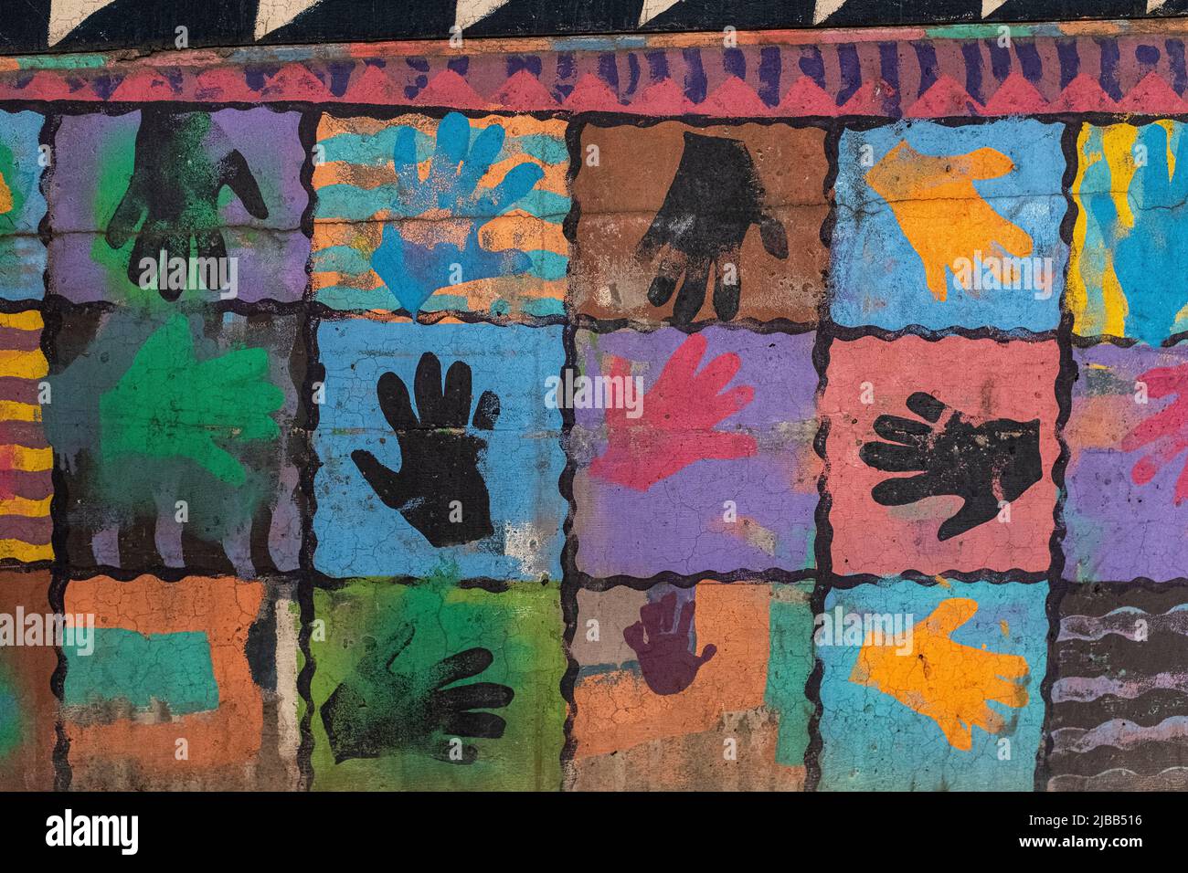 colored hand prints on wall of parking lot in downtown Albuquerque, New Mexico Stock Photo