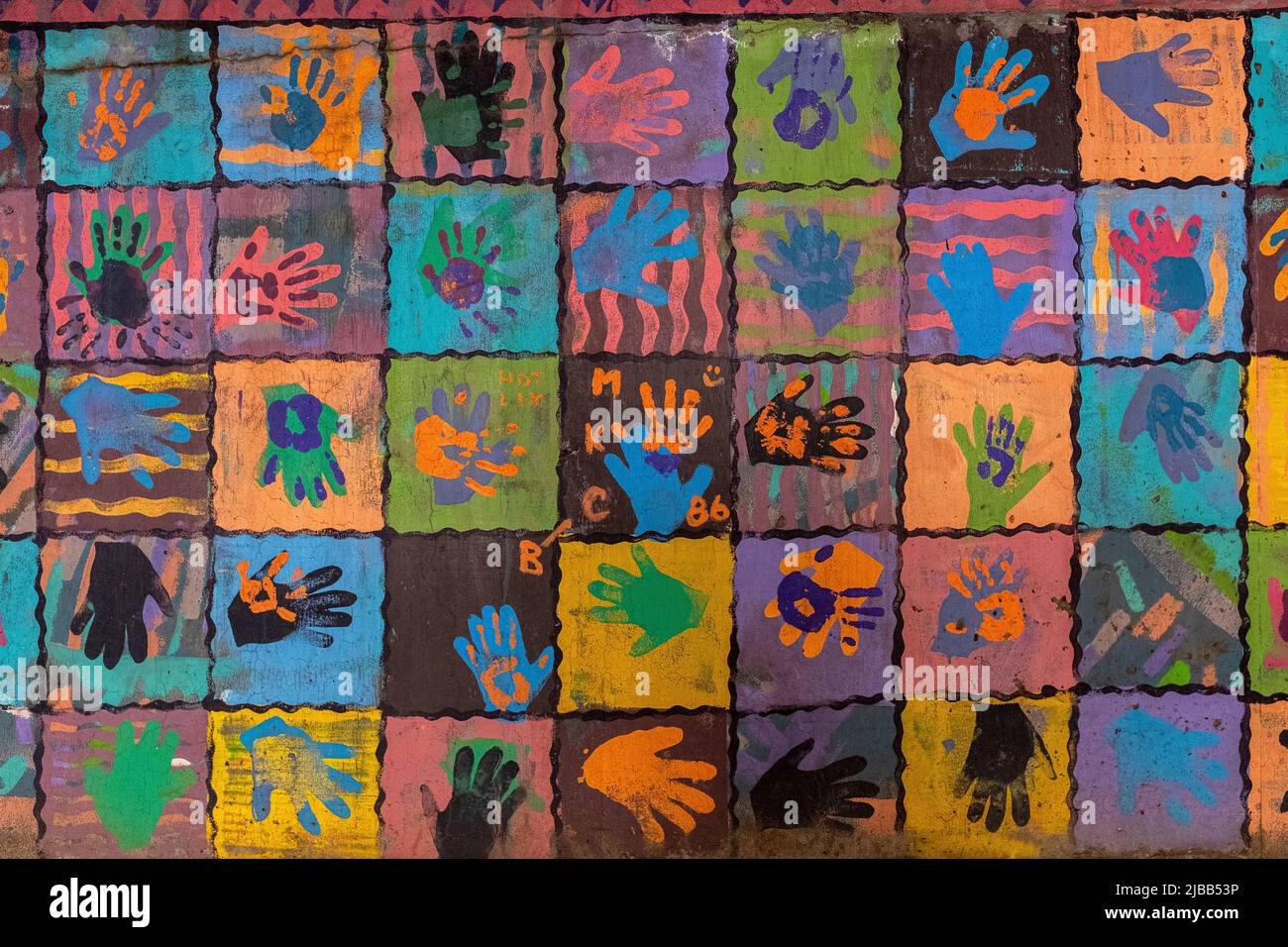 colored hand prints on wall of parking lot in downtown Albuquerque, New Mexico Stock Photo