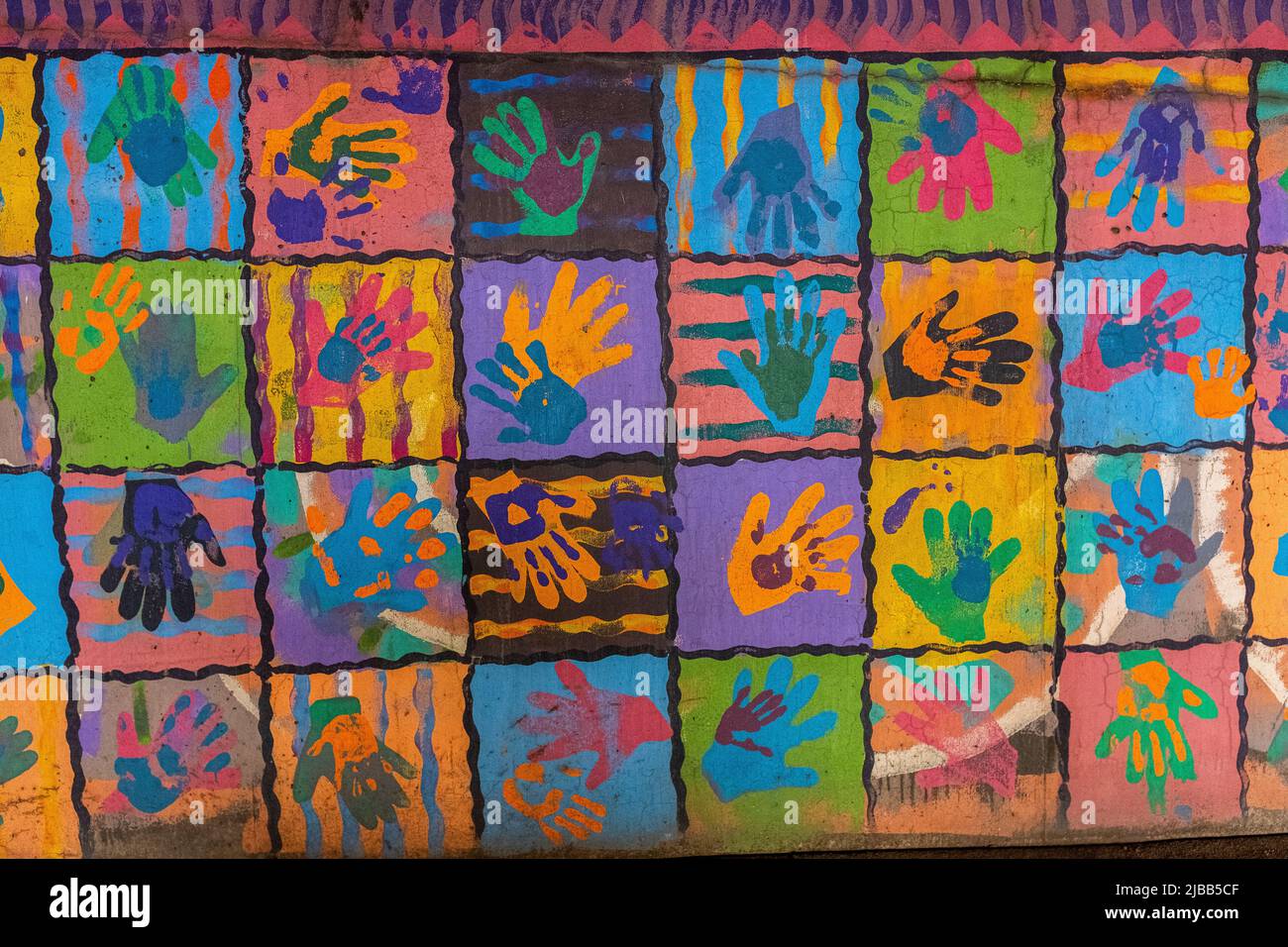 colored hand prints on wall of parking lot in downtown Albuquerque, New Mexico Stock Photo