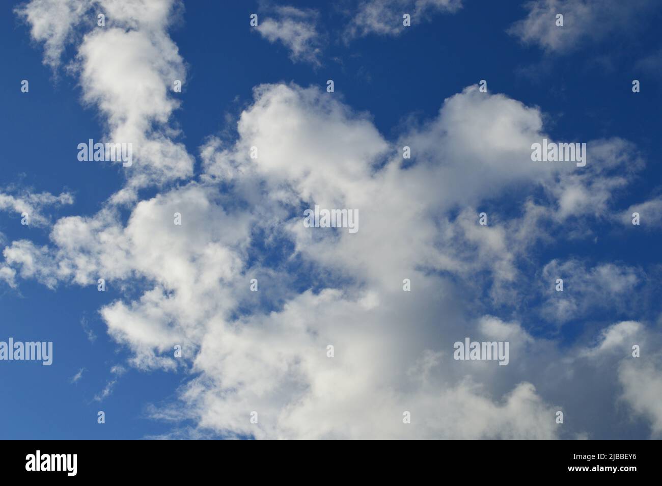 Soft white clouds floating in an azure sky Stock Photo