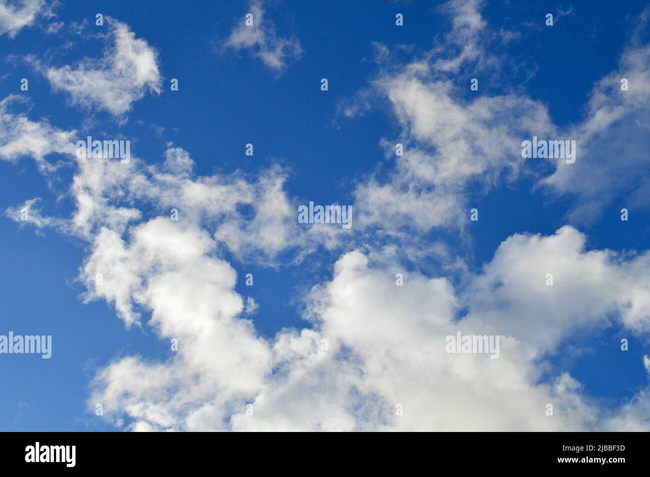Soft white clouds floating in an azure sky Stock Photo