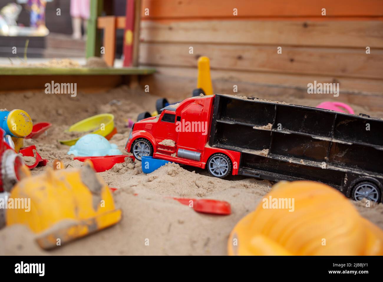 Sandbox outdoor. Children's wooden sandbox with various toys for the