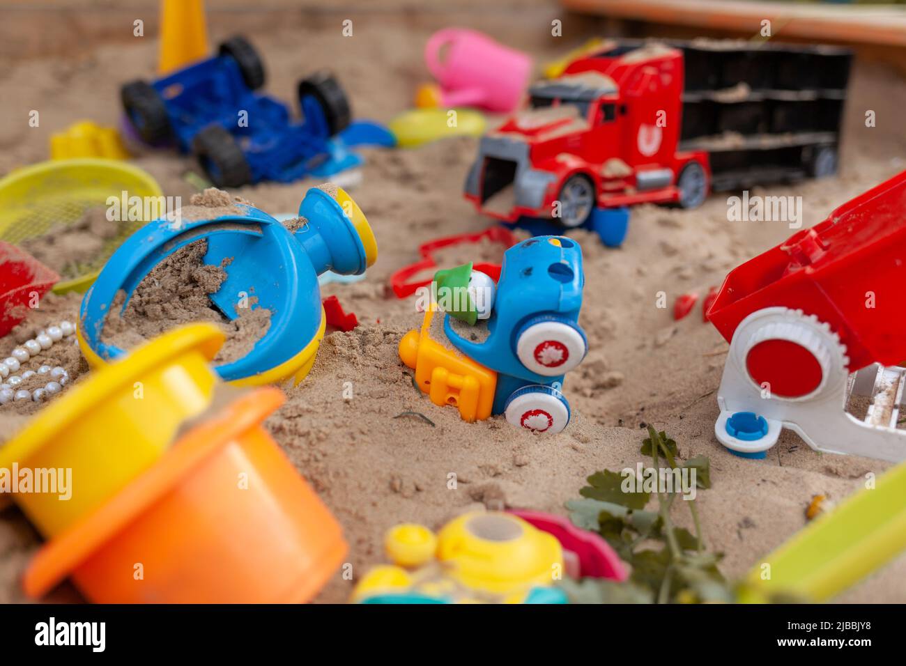 Sandbox outdoor. Children's wooden sandbox with various toys for the