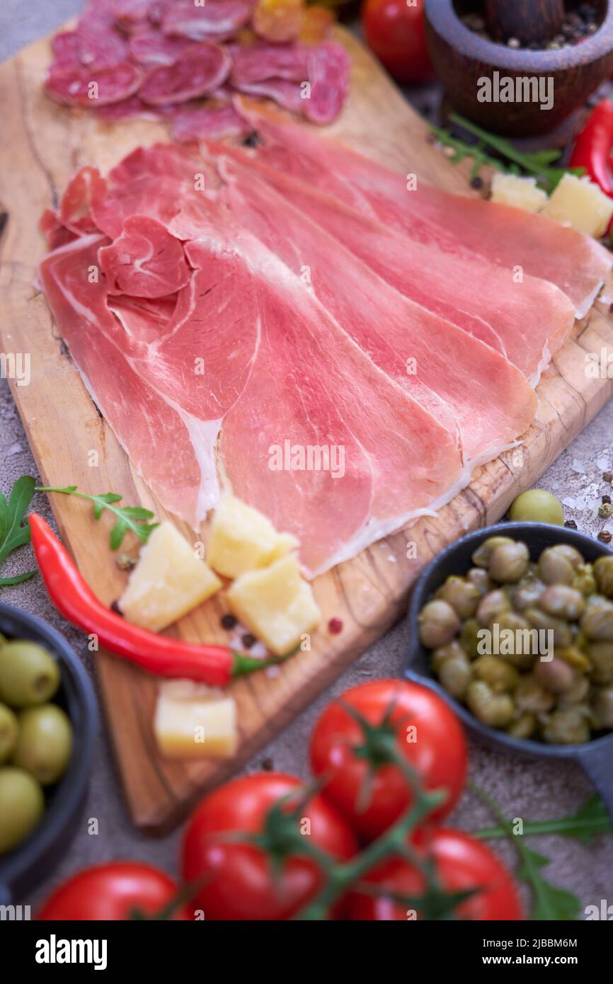 Meat antipasto platter on stone table Sliced fuet salami sausage