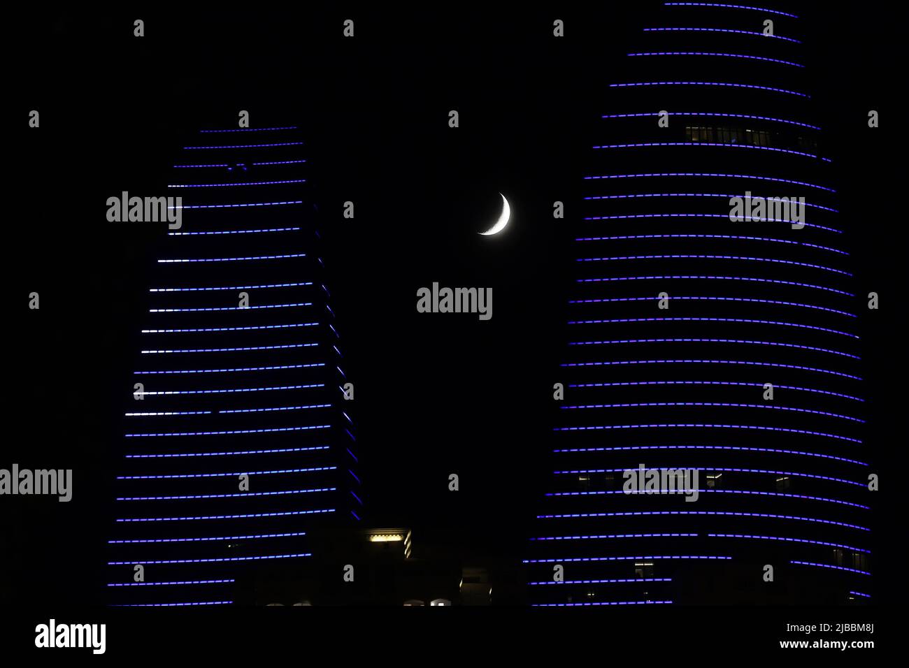 Baku city. Azerbaijan. 23.07.2020 year. Big moon near the house with office rooms. Stock Photo