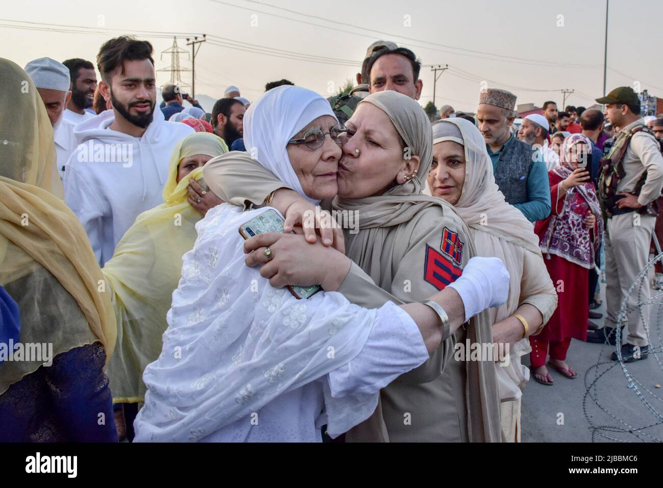 Srinagar, India. 05th June, 2022. A police officer kisses a Kashmiri ...