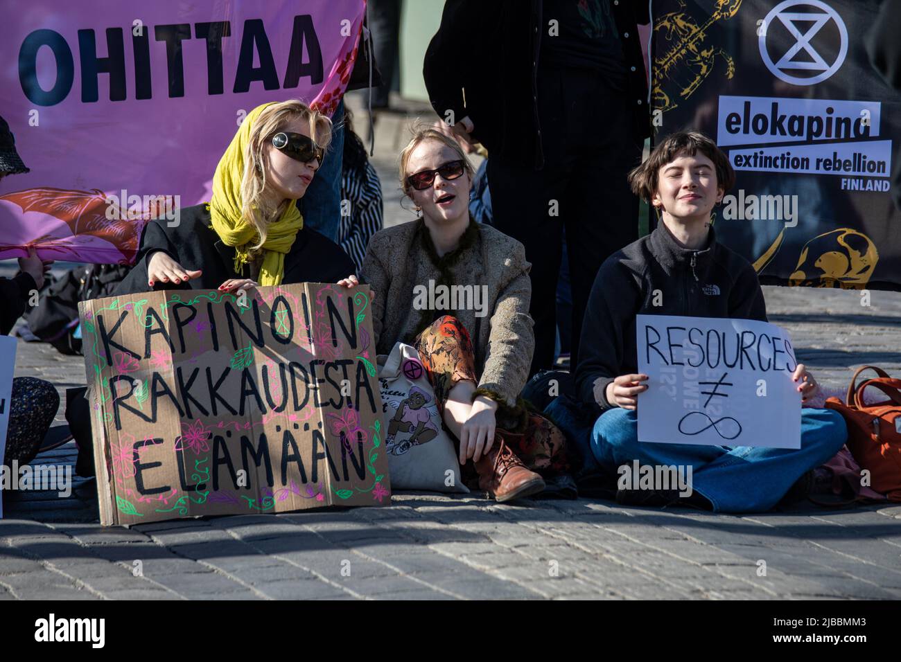 Kapinoin rakkaudesta elämään. Young women with hand-written signs at Elokapina overconsumption protest blocking Mannerheimintie in Helsinki, Finland. Stock Photo