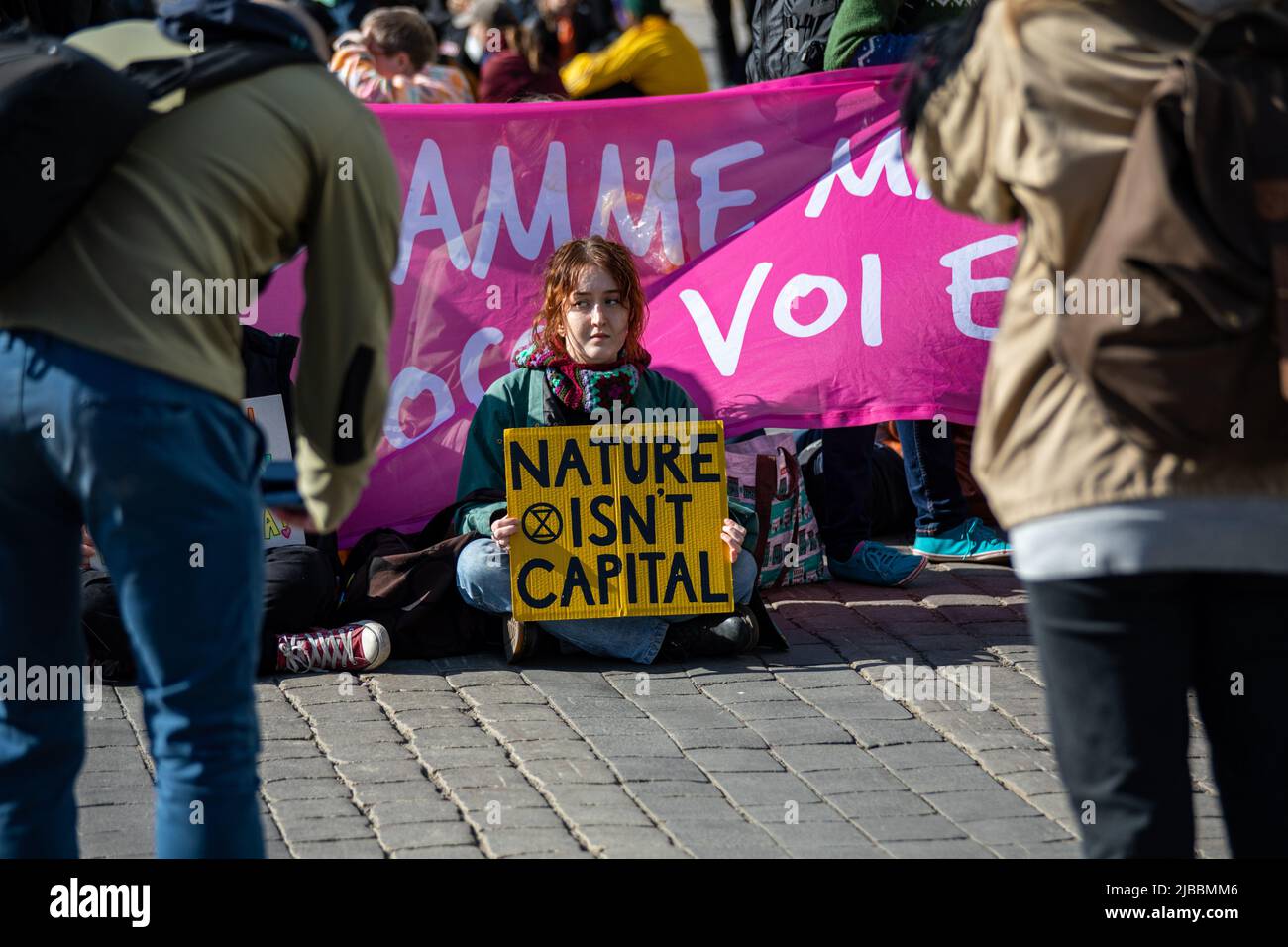 Nature isn't capital. Demonstrator holding hand-written sign at Elokapina or Extinction Rebellion Finland climate change protest in Helsinki, Finland. Stock Photo