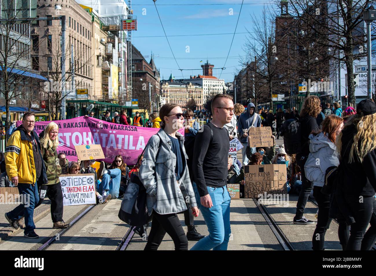 People passing Elokapina or Extinction Rebellion Finland street blocking demonstration in Helsinki, Finland. Stock Photo