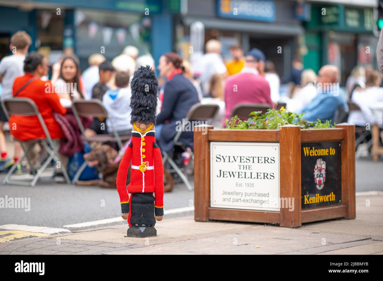 A bollard which has been yarn-bombed for the Platinum Jubilee. Platinum Jubilee celebrations in Kenilworth, Warwickshire. Thousands of locals enjoyed the main road closure, to sit on picnic tables and celebrate the Queen's 70th anniversary of her reign. Stock Photo