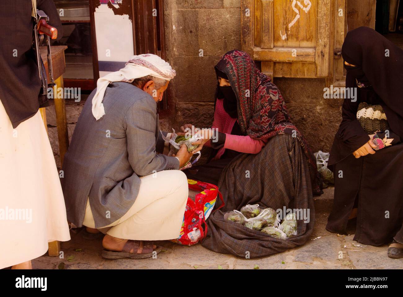 An elderly Yemeni woman selling the famous Qat plant in Yemen Stock Photo