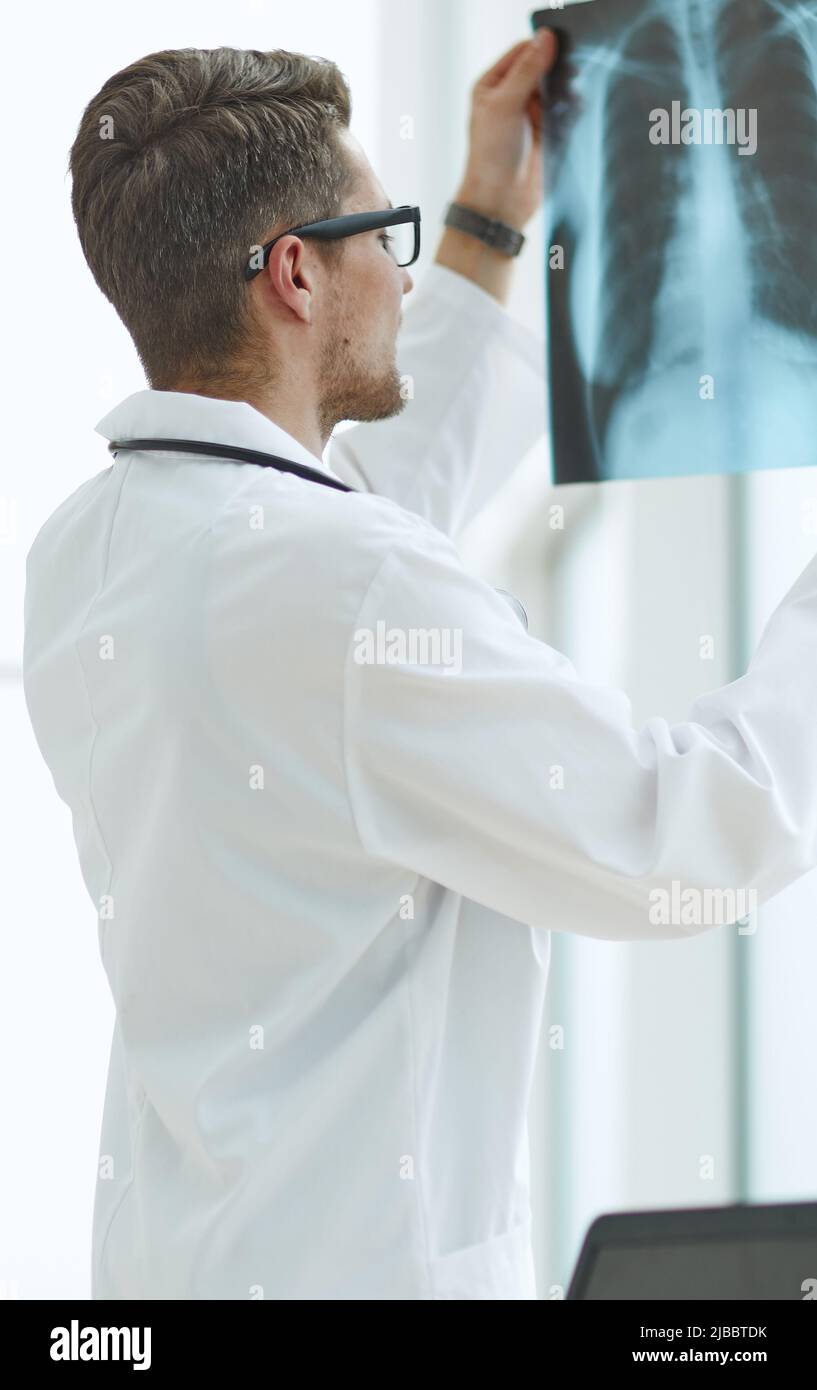 Male doctor radiologist examines xrays in a medical office Stock Photo