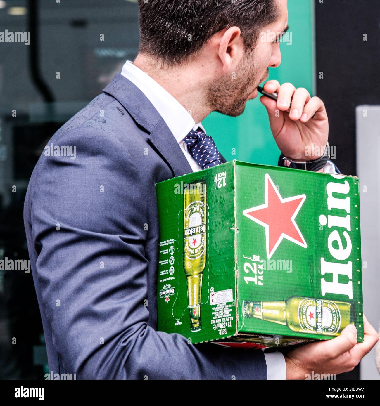 Epsom Surrey, London UK, June 04 2022, Man Carrying A Box Of Heineken Beer Of Lager To Cazoo Derby Festival Stock Photo