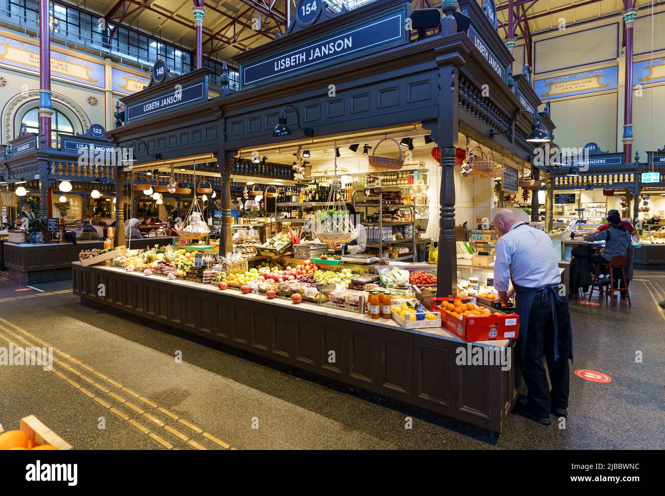 Stockholm, Sweden - February 15 2022: People shop for fresh food in the famous Östermalms Saluhall food hall that dates back to 1888 in Stockholm, Swe Stock Photo