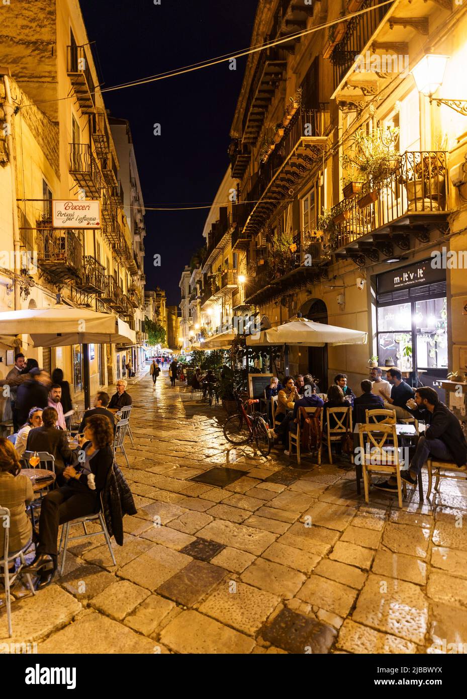 Palermo, Italy - October 21 2021: People enjoy a drink and eat out in the terraces in the Palermo city historic center at nightl in Sicily largest cit Stock Photo