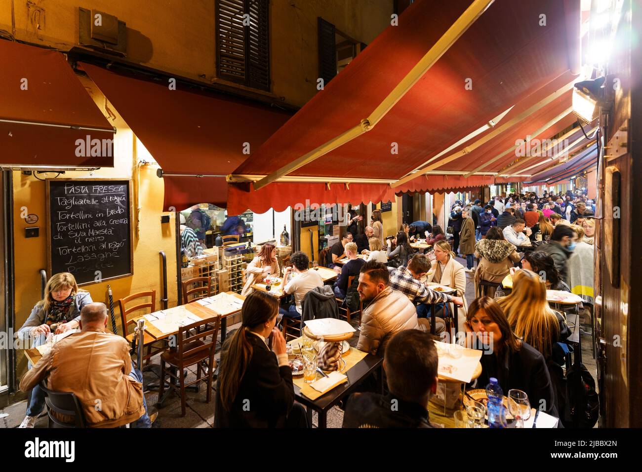 Bologna, Italy - October 29 2021: People enjoy food and drinks in the famous Pescherie Vecchie street lined with authentic bar and restaurants in Bolo Stock Photo