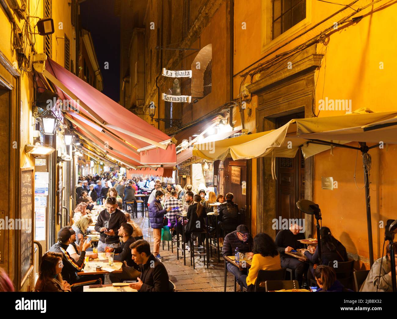 Bologna, Italy - October 29 2021: People enjoy food and drinks in the famous Pescherie Vecchie street lined with authentic bar and restaurants in Bolo Stock Photo