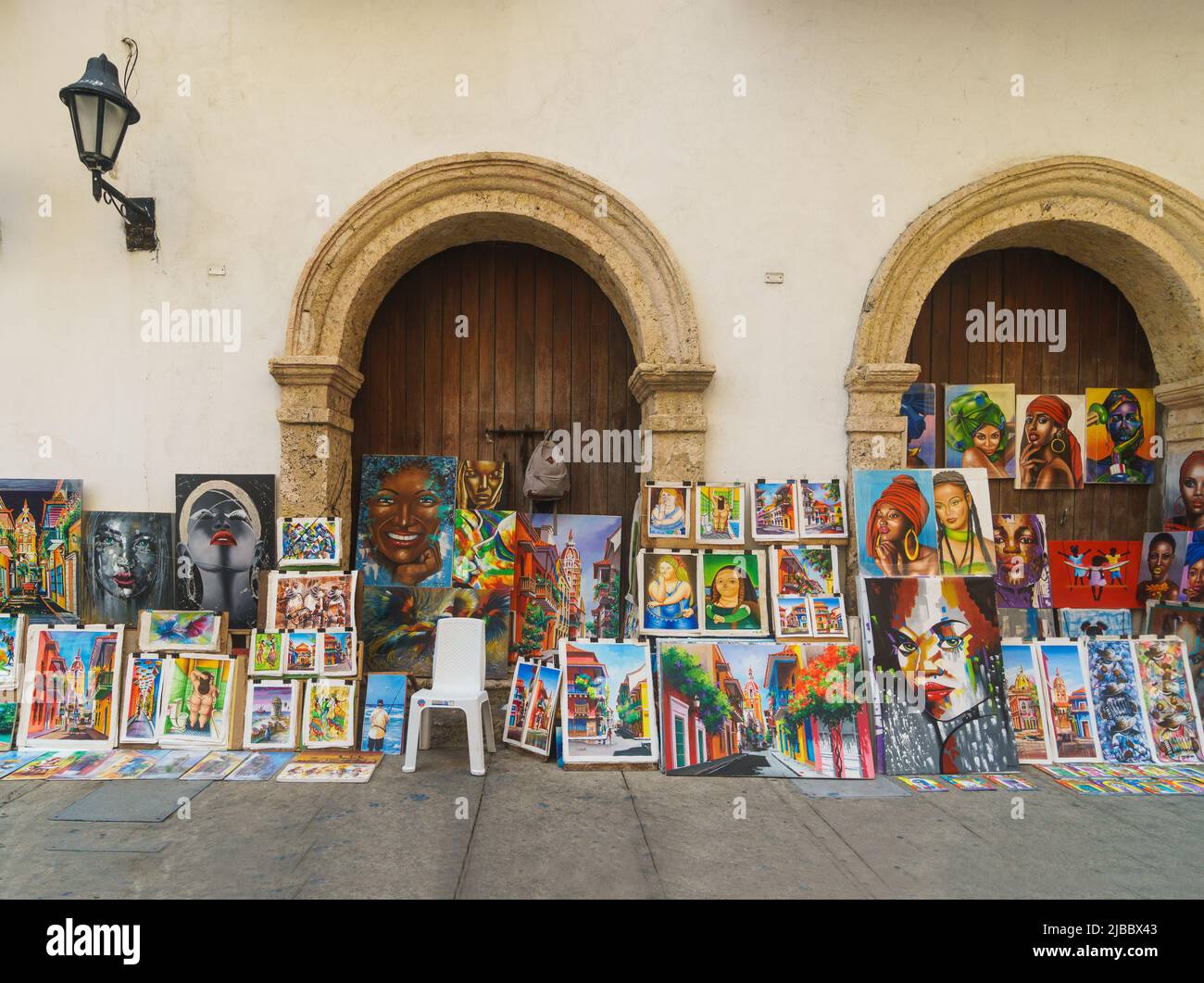 Cartagena, Colombia - May 07 2022: Paintings representing Caribbean woman and city views are displayed in the street of the Cartagenia colonial old to Stock Photo