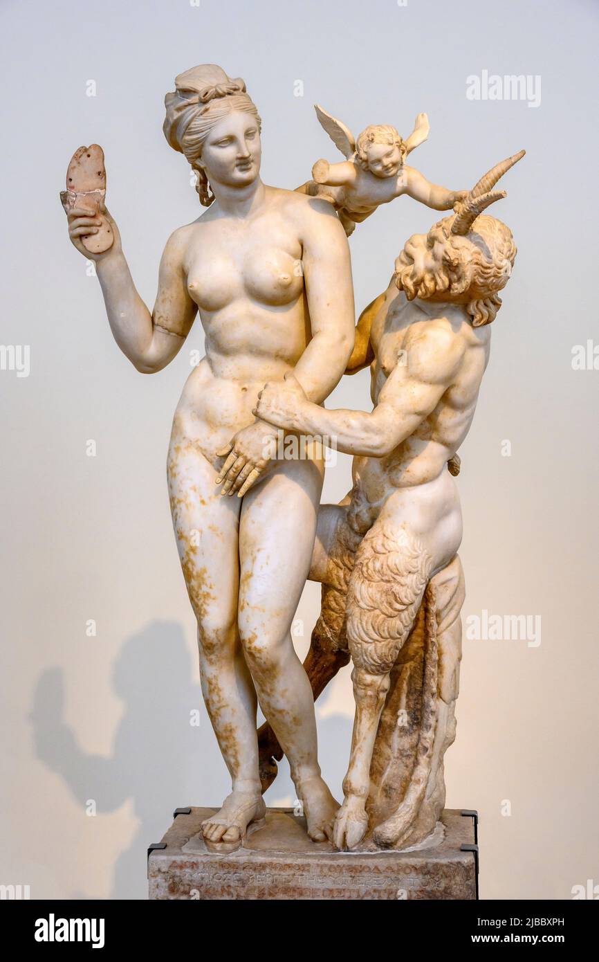 Parian marble sculpture of The Greek goddess Aphrodite with Pan and Eros. Aphrodite attempts to fend off the advances of Pan with the help of Eros. Fo Stock Photo