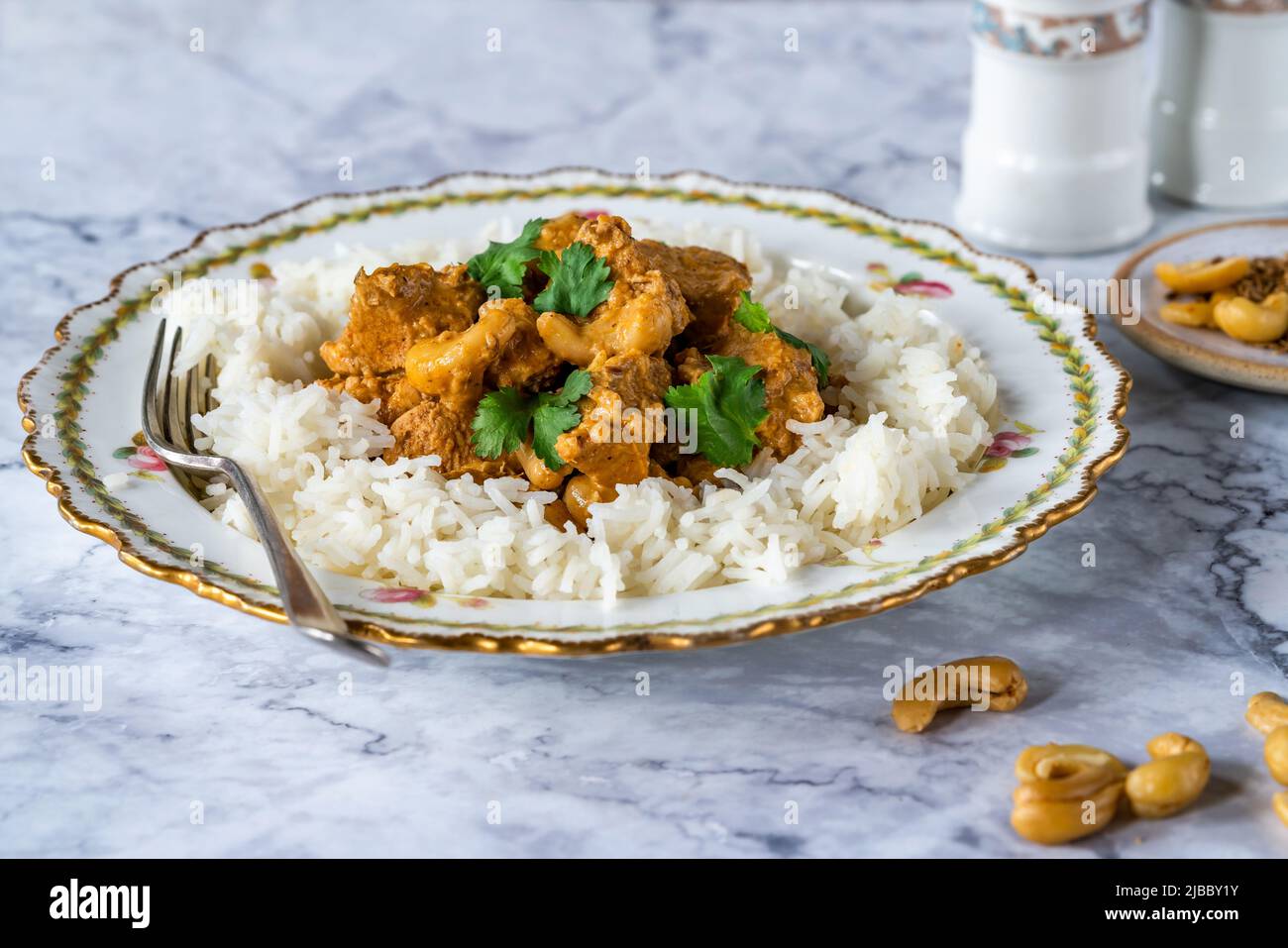 Chicken korma curry with cashew nuts and rice Stock Photo