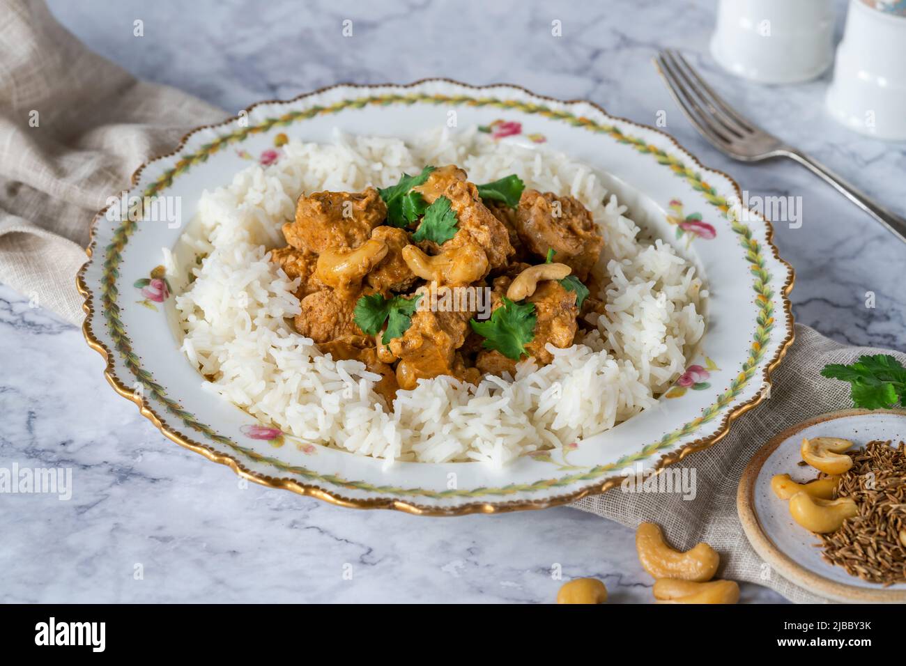 Chicken korma curry with cashew nuts and rice Stock Photo
