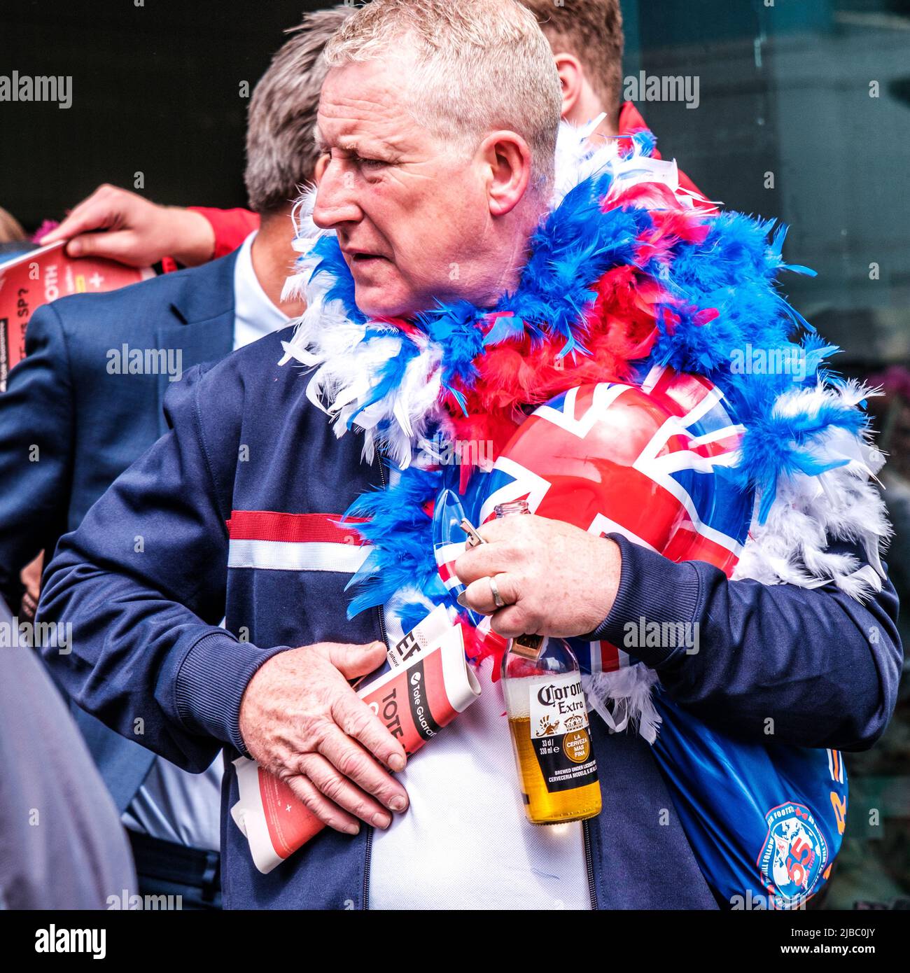 Epsom Surrey, London UK, June 04 2022, Senior Man With Patriotic Union Flas Bowler Hat Holding Bottle Of Beer Stock Photo