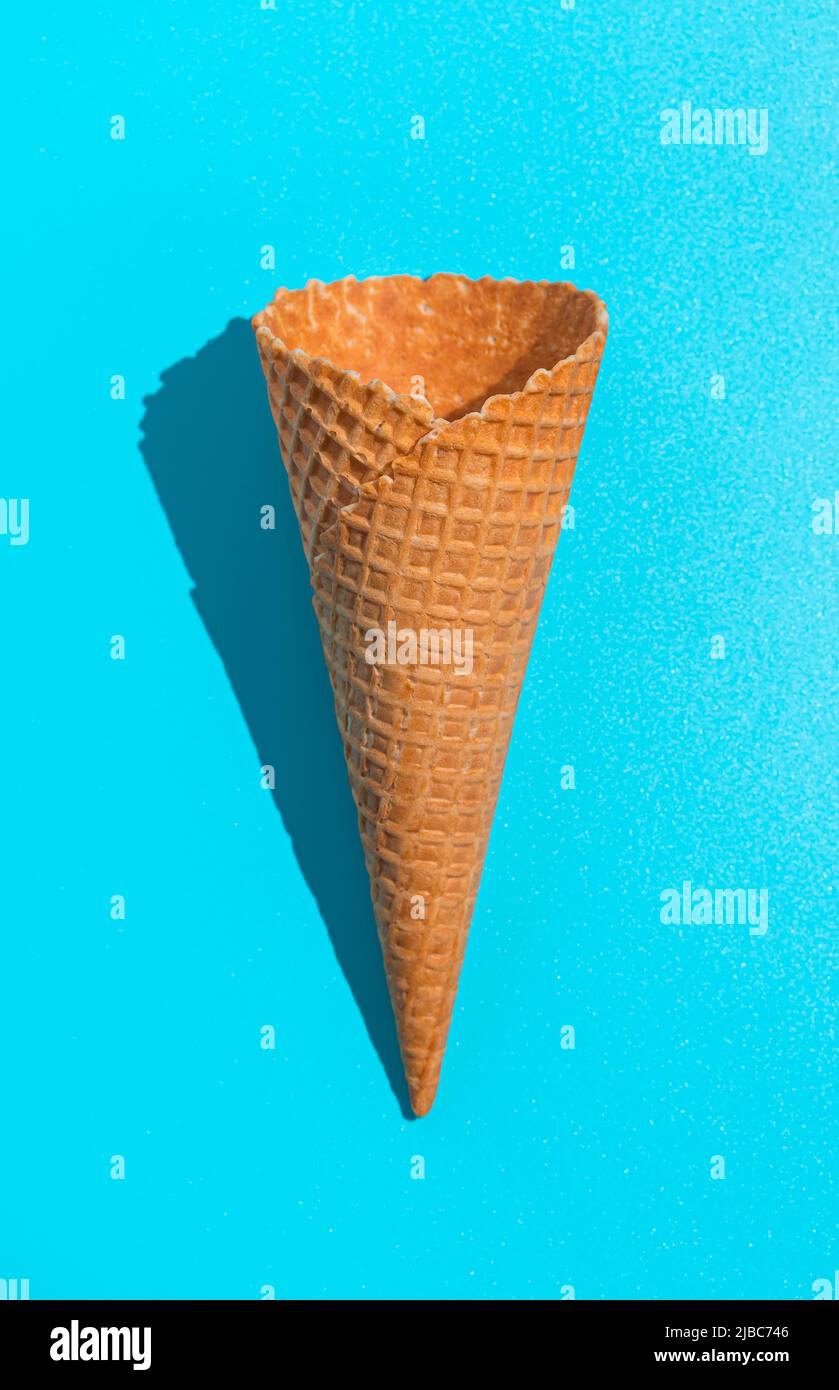 Waffle ice cream cone on a blue background. Top view, vertical Stock ...