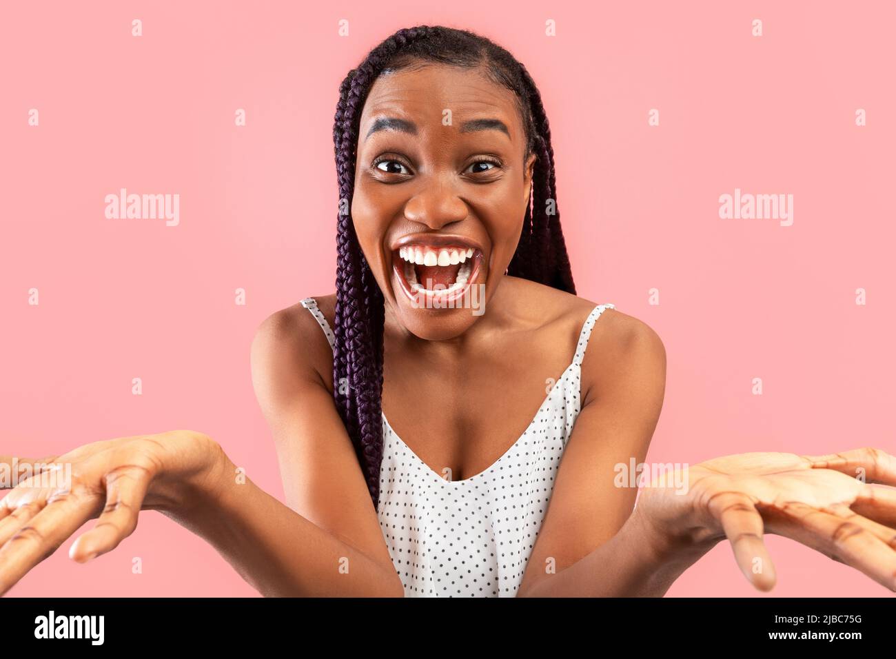 Emotional young black lady feeling excited, shouting OMG or WOW