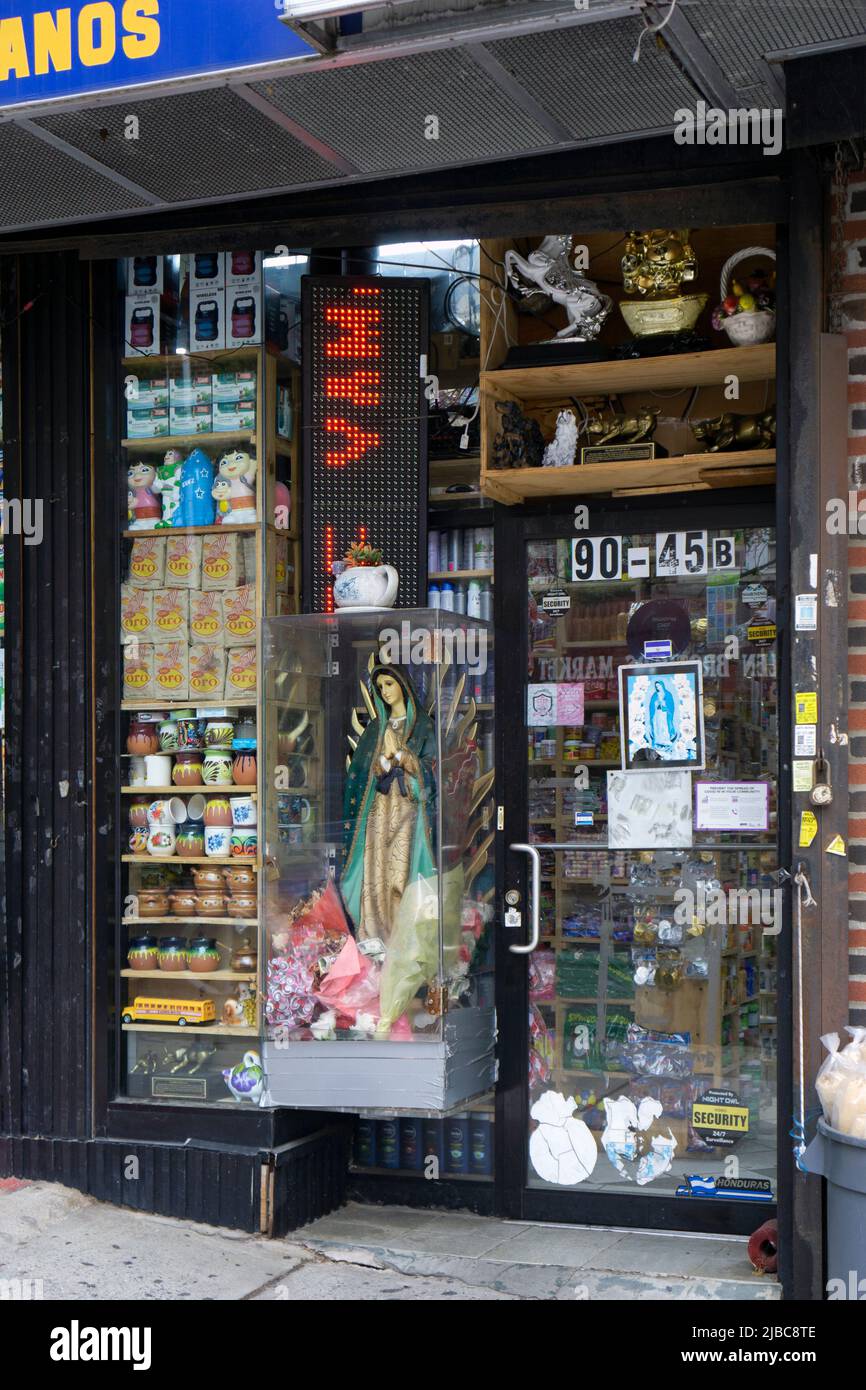 The exterior of EL RINCONSITO who sell Central American products and have a statue of Virgin Mary with a donation slot in their window. Stock Photo