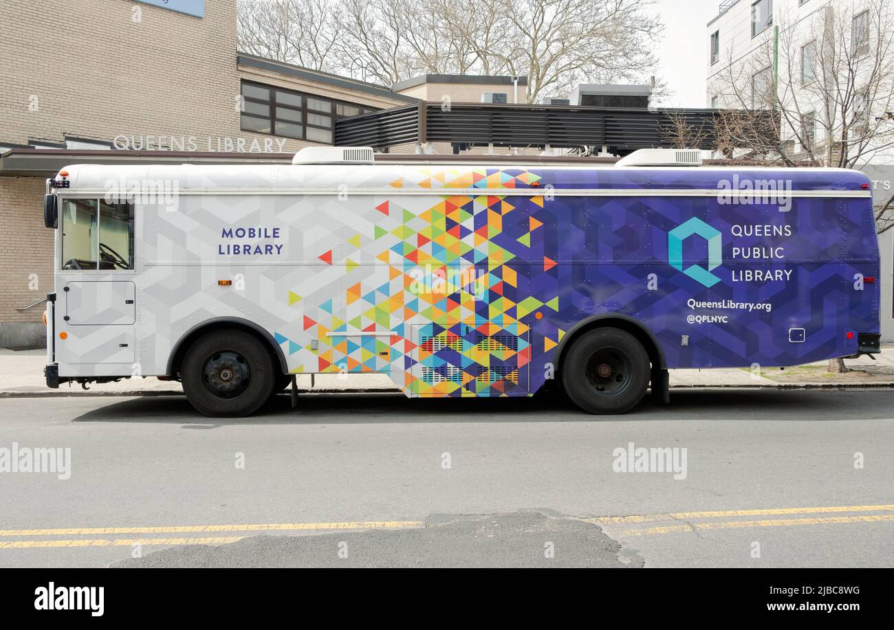 The Queens Public Library bookmobile parked on Broadway near Steinway Street in Astoria Queens, New York City. Stock Photo
