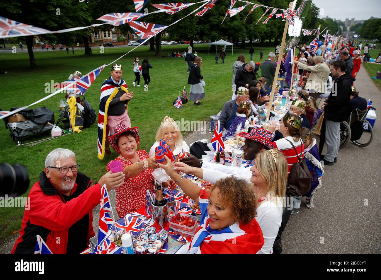 People dine at a picnic table as they take part in the Big Jubilee Lunch on  The Long Walk as part of celebrations marking the Platinum Jubilee of  Britain's Queen Elizabeth, in