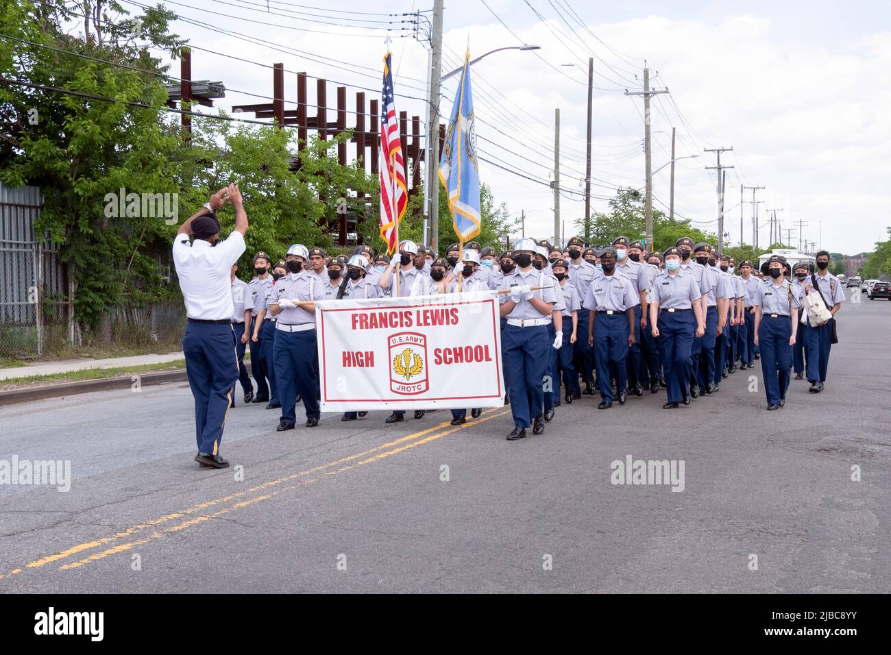 The Francis Lewis High School JrOTC marching in the College Point, Queens Memorial Day Parade. A diverse group of teens with most wearing masks. Stock Photo